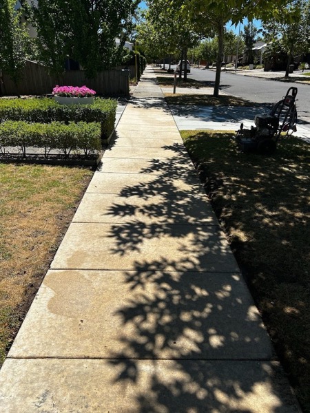 The same footpath photographed after pressure washing