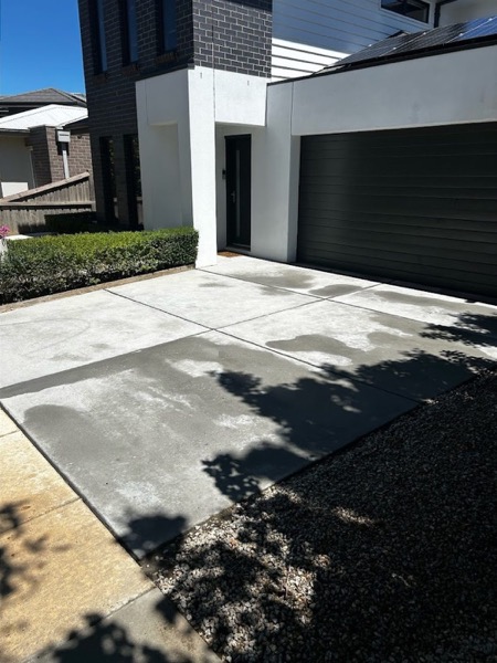 The same driveway photographed after pressure washing