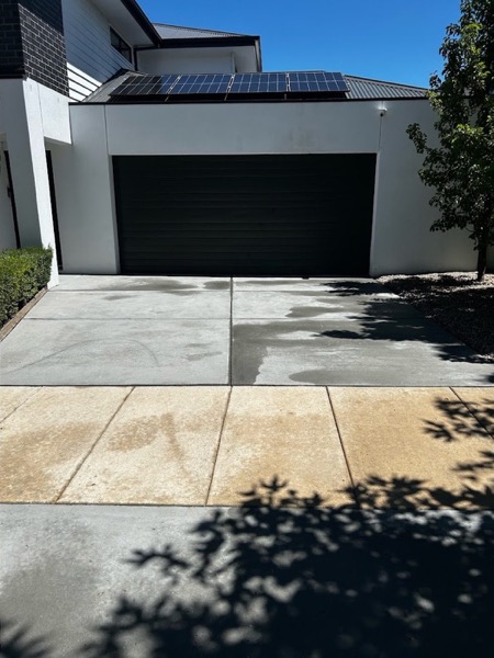 The same driveway photographed after pressure washing