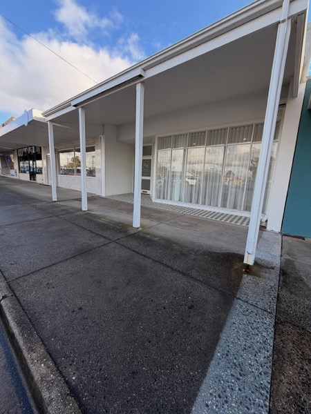 A concrete footpath under the verandah of a Ballarat shopfront