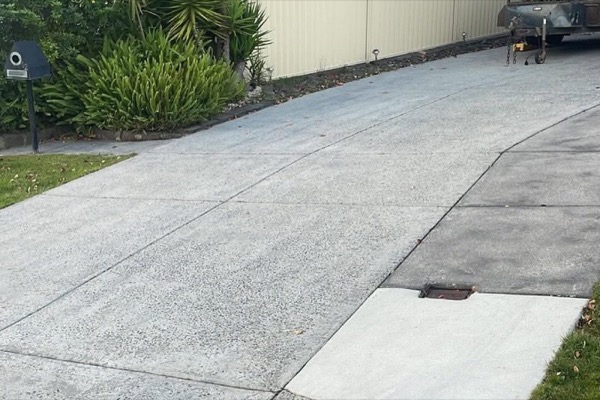 A concrete driveway running out to the street