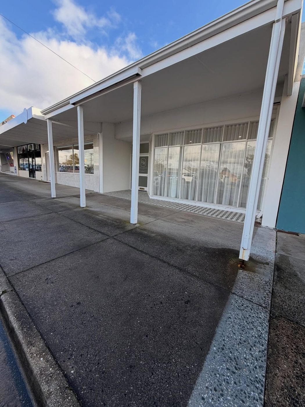 A concrete footpath under the verandah of a Ballarat shopfront
